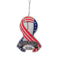 A plush keepsake in the shape of a ribbon with an American flag design and 'Never Forget 9/11' text, suspended by metallic loop.