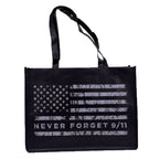 A black tote bag with a grey American flag design and the text 'NEVER FORGET 9/11' on it.